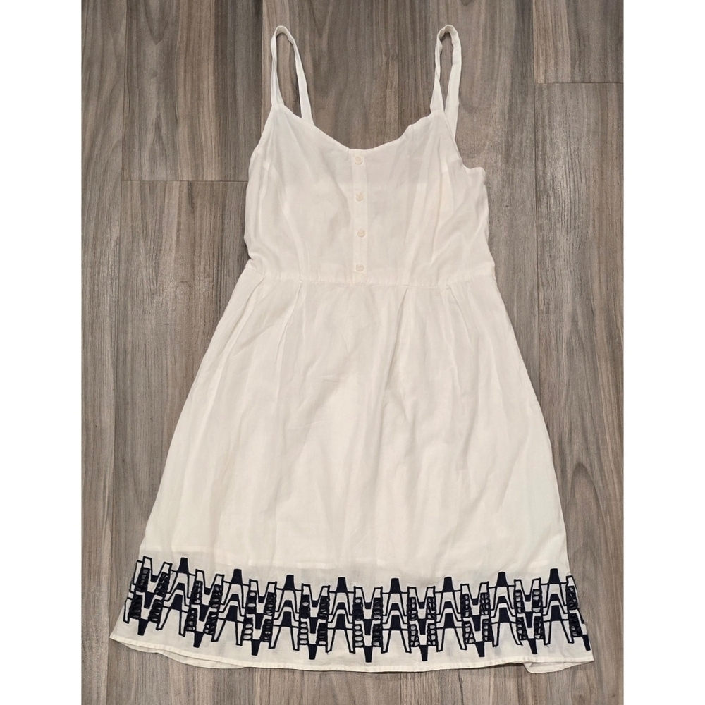 Charming White Summer Dress with Embroidered Hemline